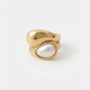 Bague dorée en acier inoxydable ornée d'un cabochon perle nacrée vue packshot studio